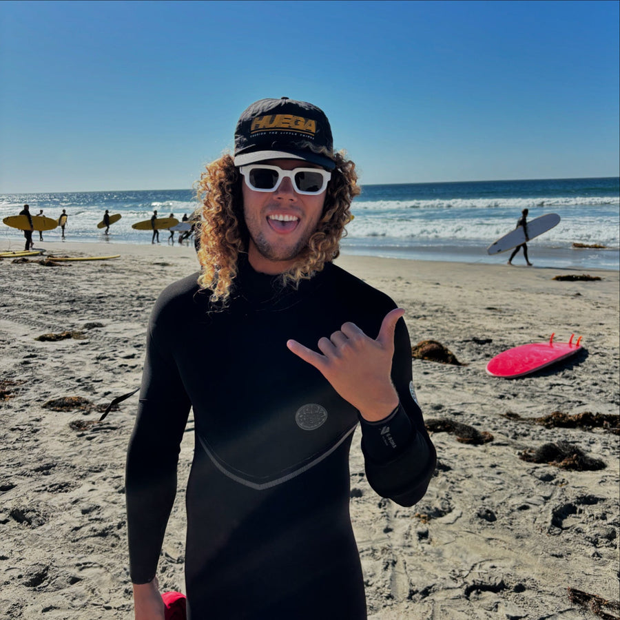 Outsiders model wearing beanie and sunglasses